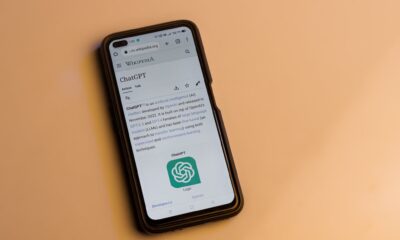 Webpage of ChatGPT, a prototype AI chatbot, is seen on the website of OpenAI, on a smartphone. Examples, capabilities, and limitations are shown.