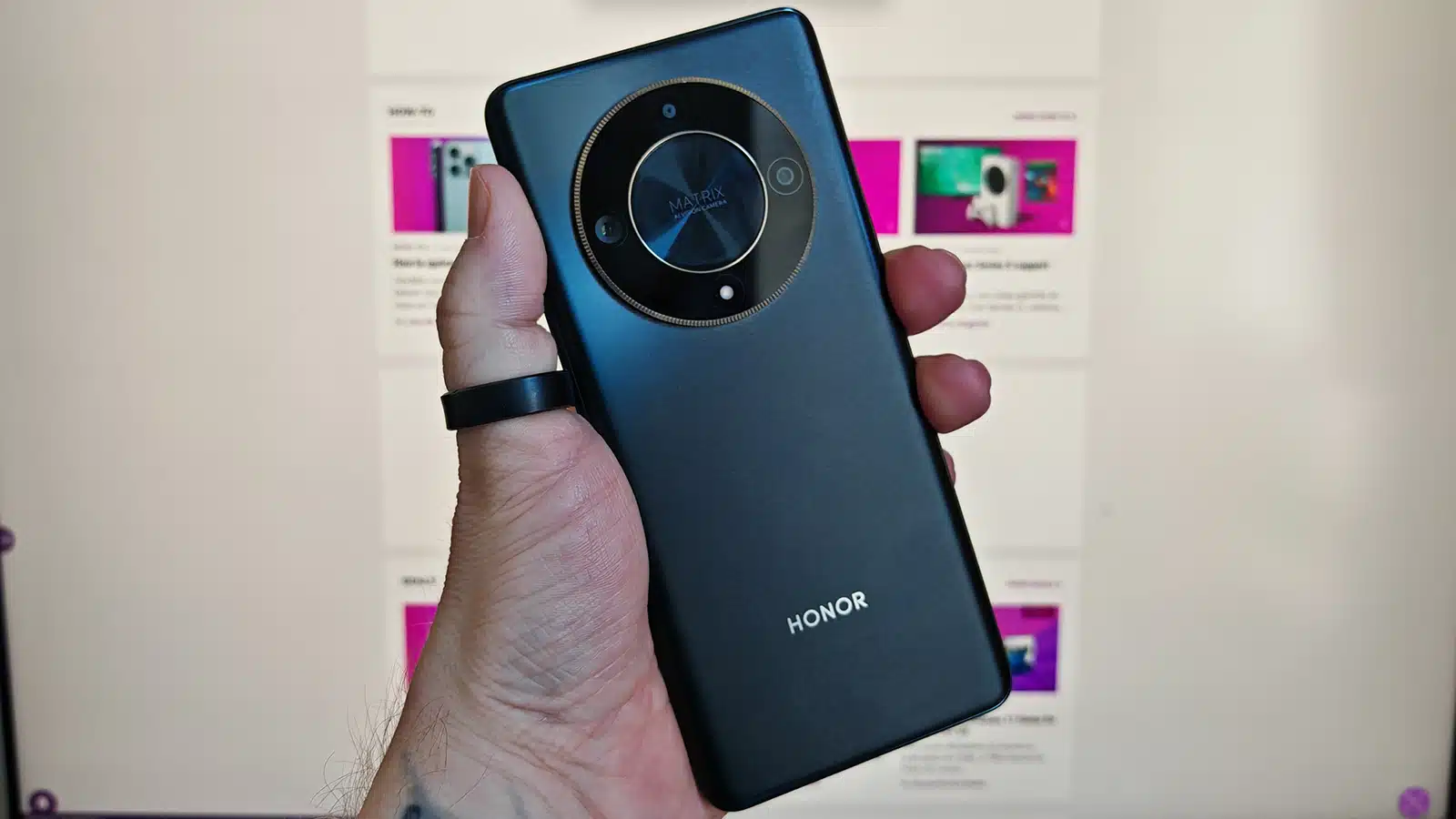 holding honor magic6 lite in hand showing rear camera