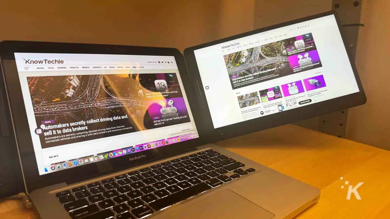 the QQH triple laptop screen extender with a laptop on a desk.