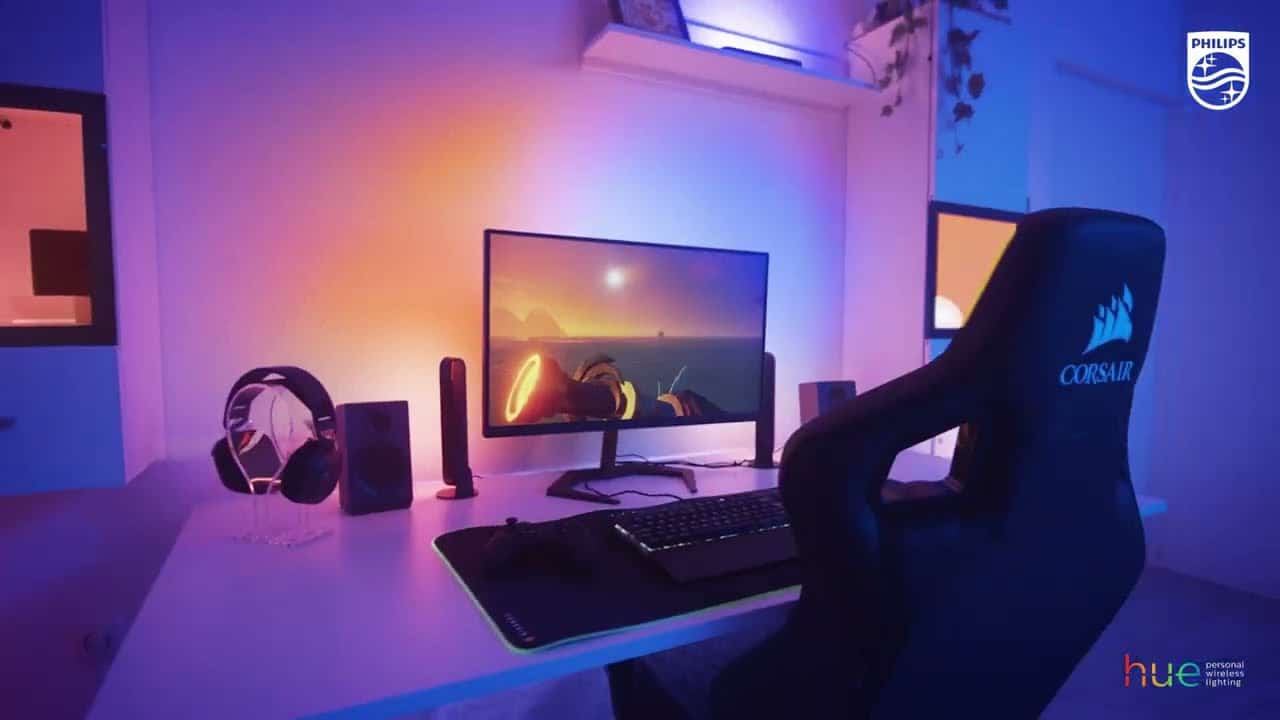 Gaming setup with colorful lighting and accessories.