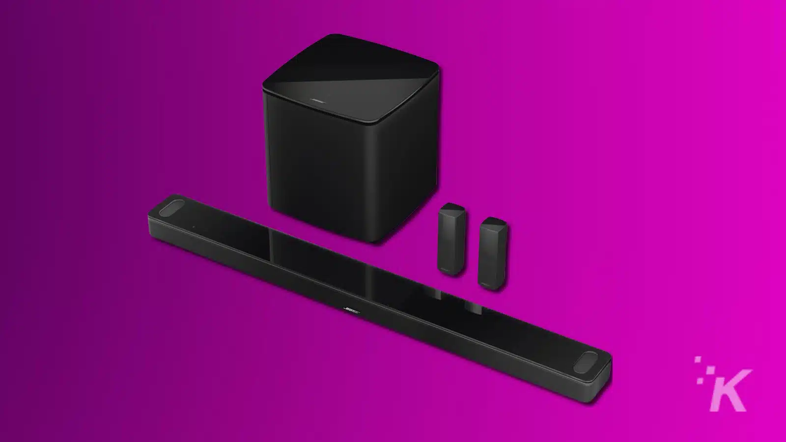 Black soundbar and speakers on purple background.