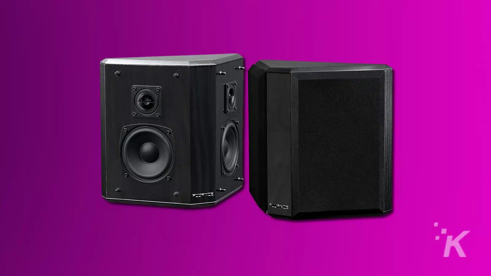 Two black bookshelf speakers on purple background.