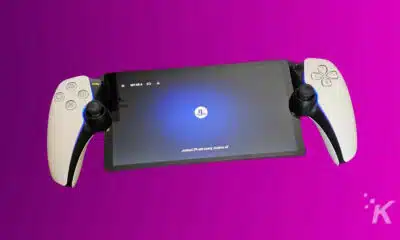 Gaming tablet with console controllers on purple background.