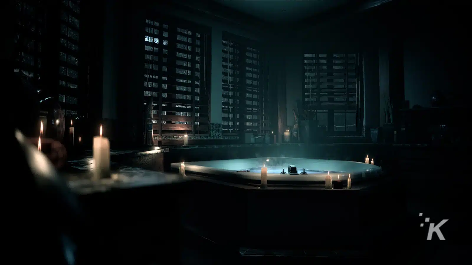 Candlelit bathtub in dark, luxurious bathroom setting.