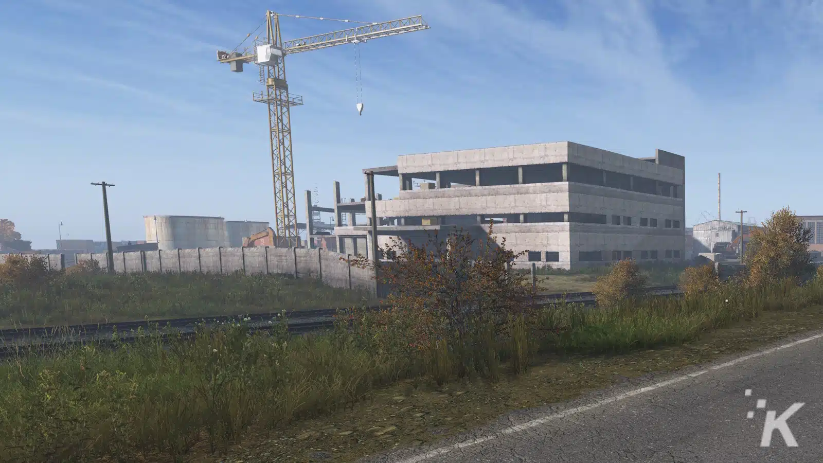 Construction site with crane and unfinished buildings.