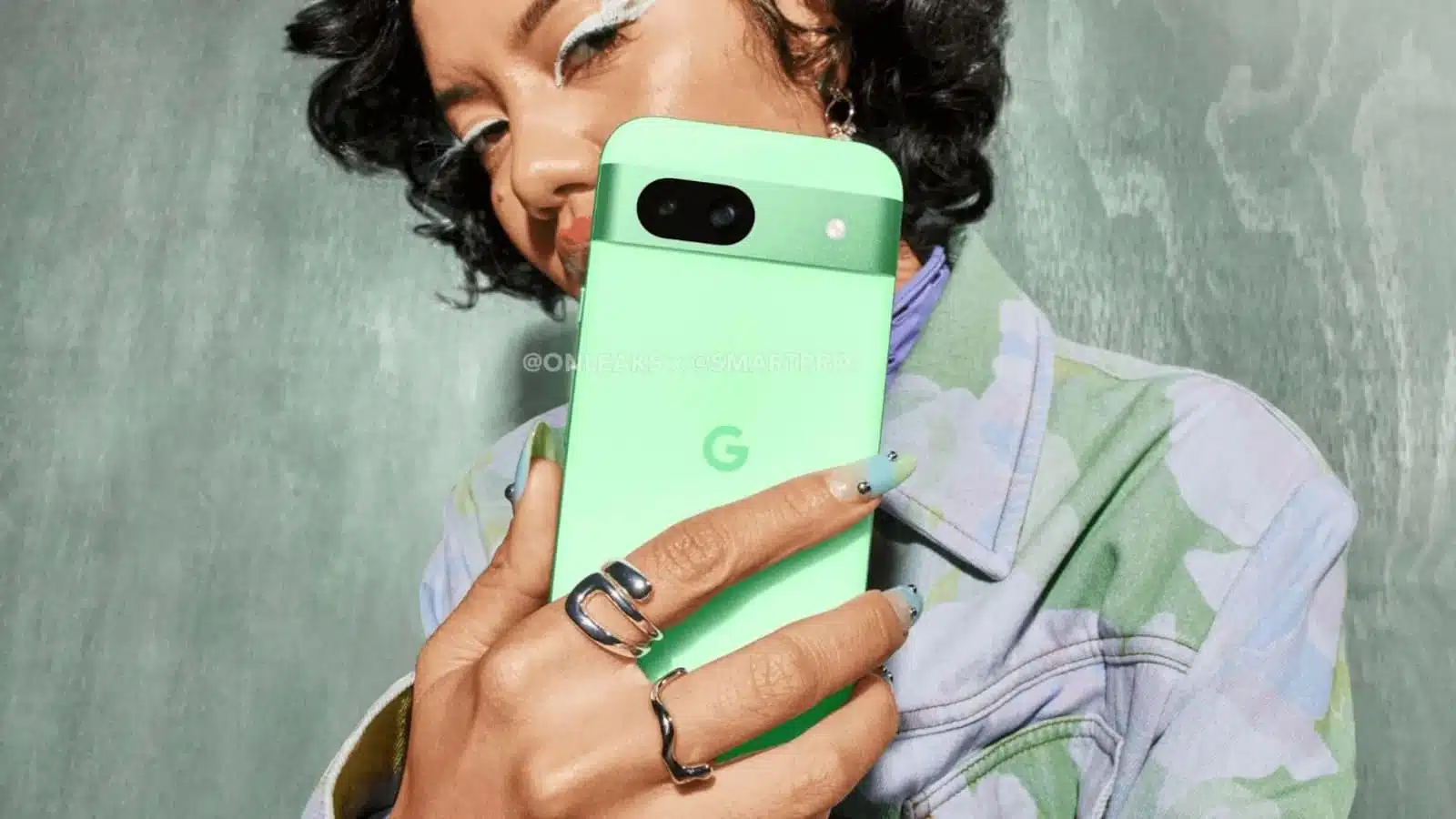 Woman holding green smartphone with dual cameras.
