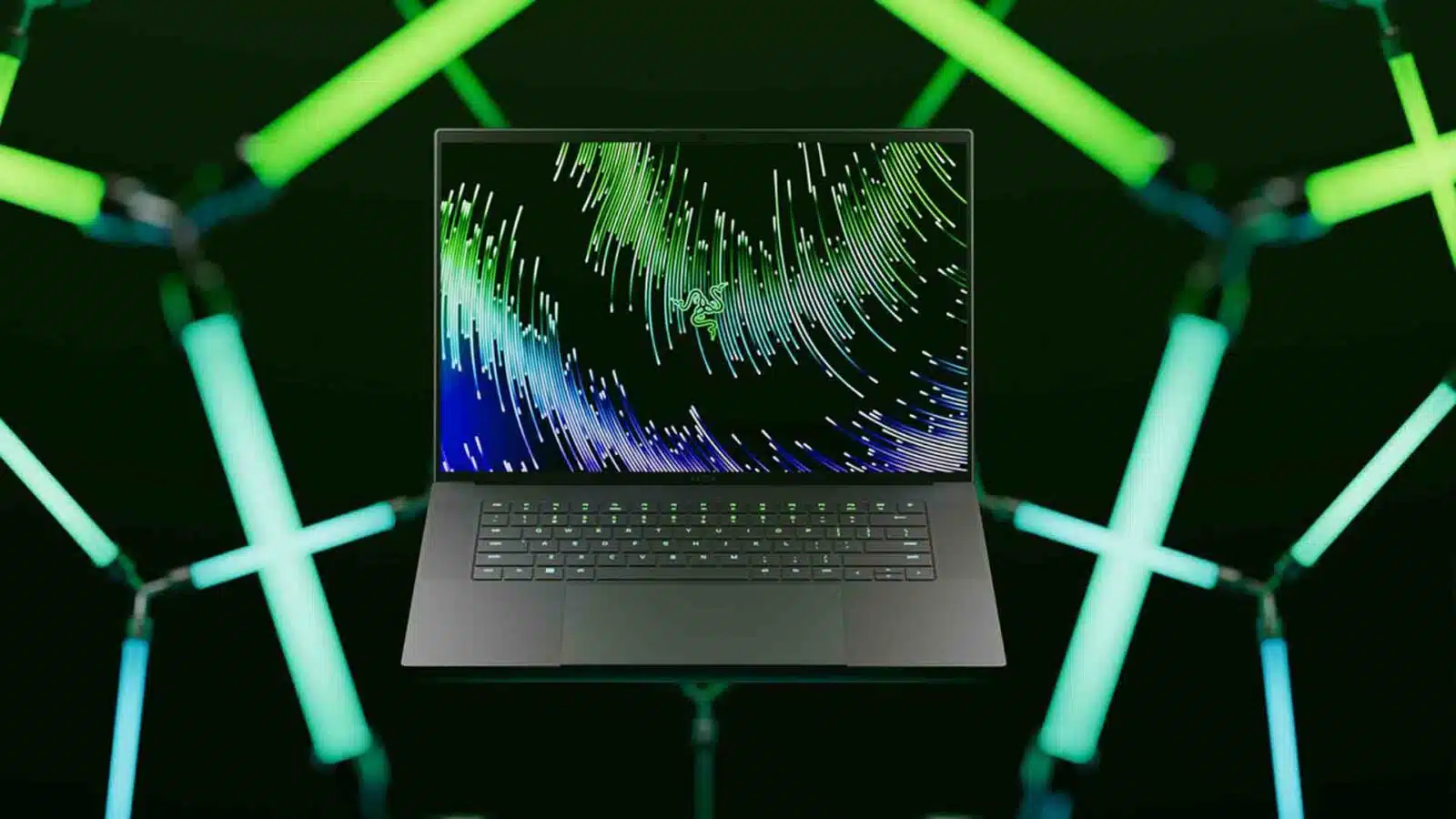 Laptop with vibrant digital art display, green neon lights. Razer 16