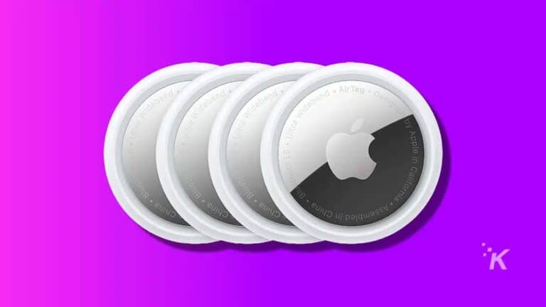 Four Apple AirTags on purple background