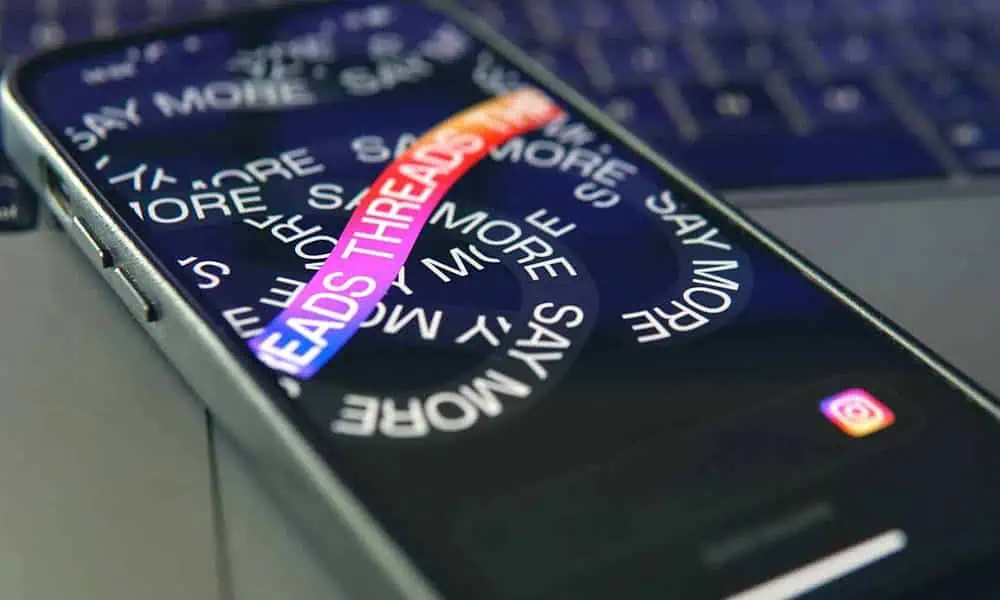 Smartphone with Threads app on screen, close-up view.