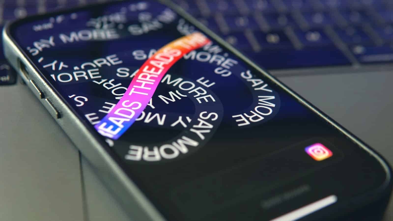 Smartphone with Threads app on screen, close-up view.