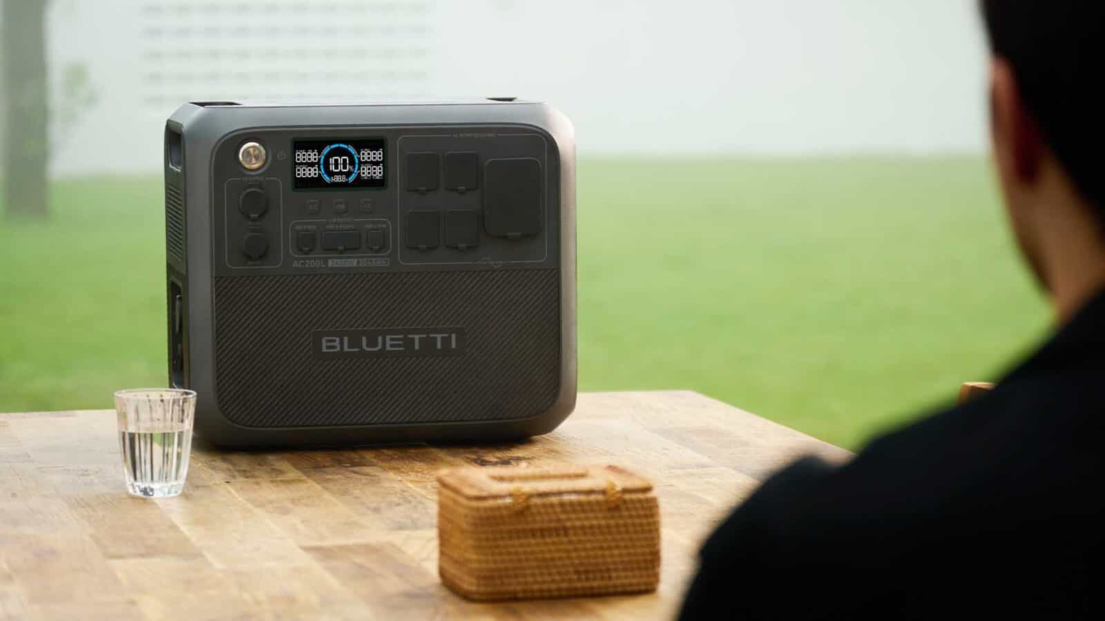 BLUETTI AC200L  power station on a wooden table outside.