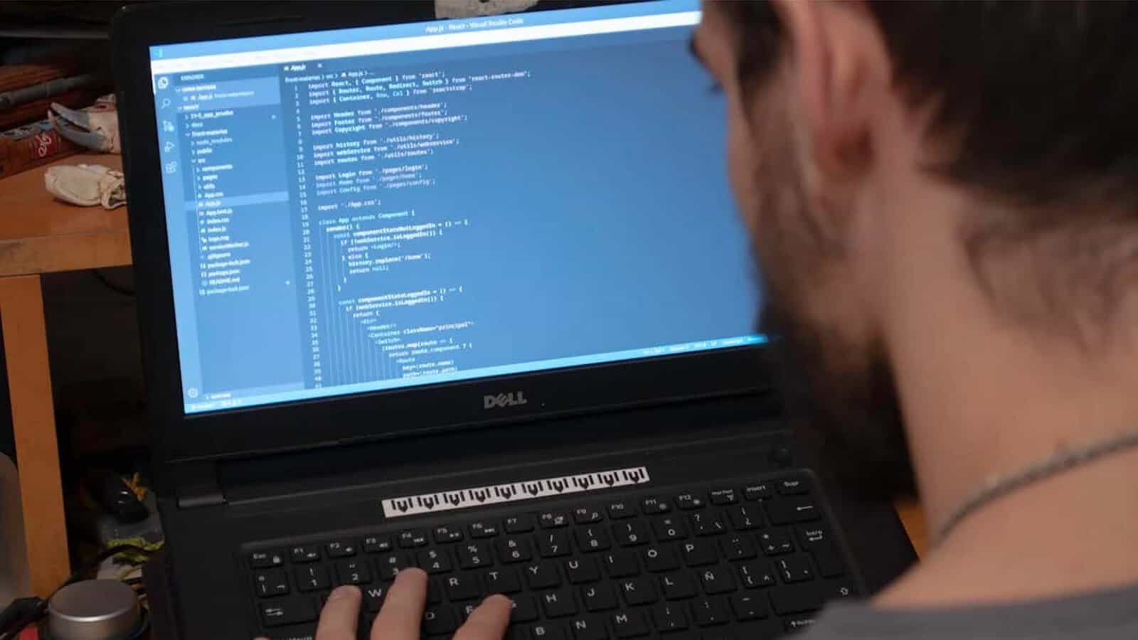 Developer coding on laptop with Visual Studio Code