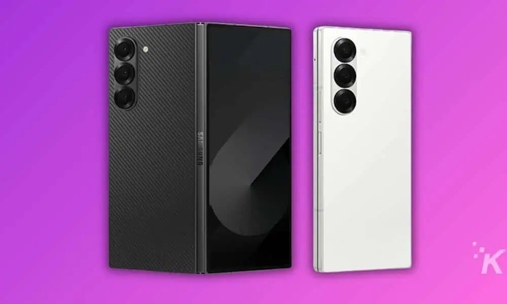 Black and white smartphones on purple background