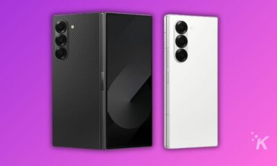 Black and white smartphones on purple background