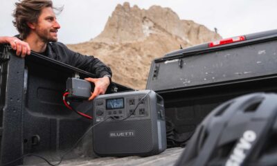 Person with portable power station in truck bed.