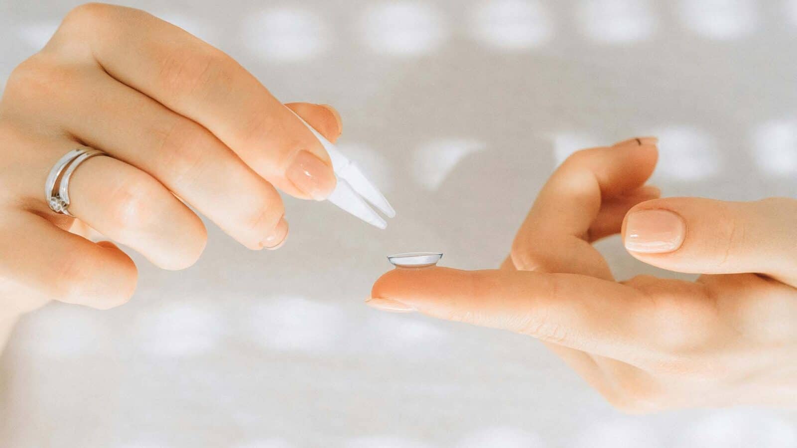 Applying contact lens with care and precision.