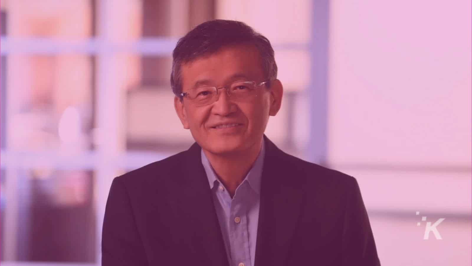 Smiling man in suit and glasses indoors