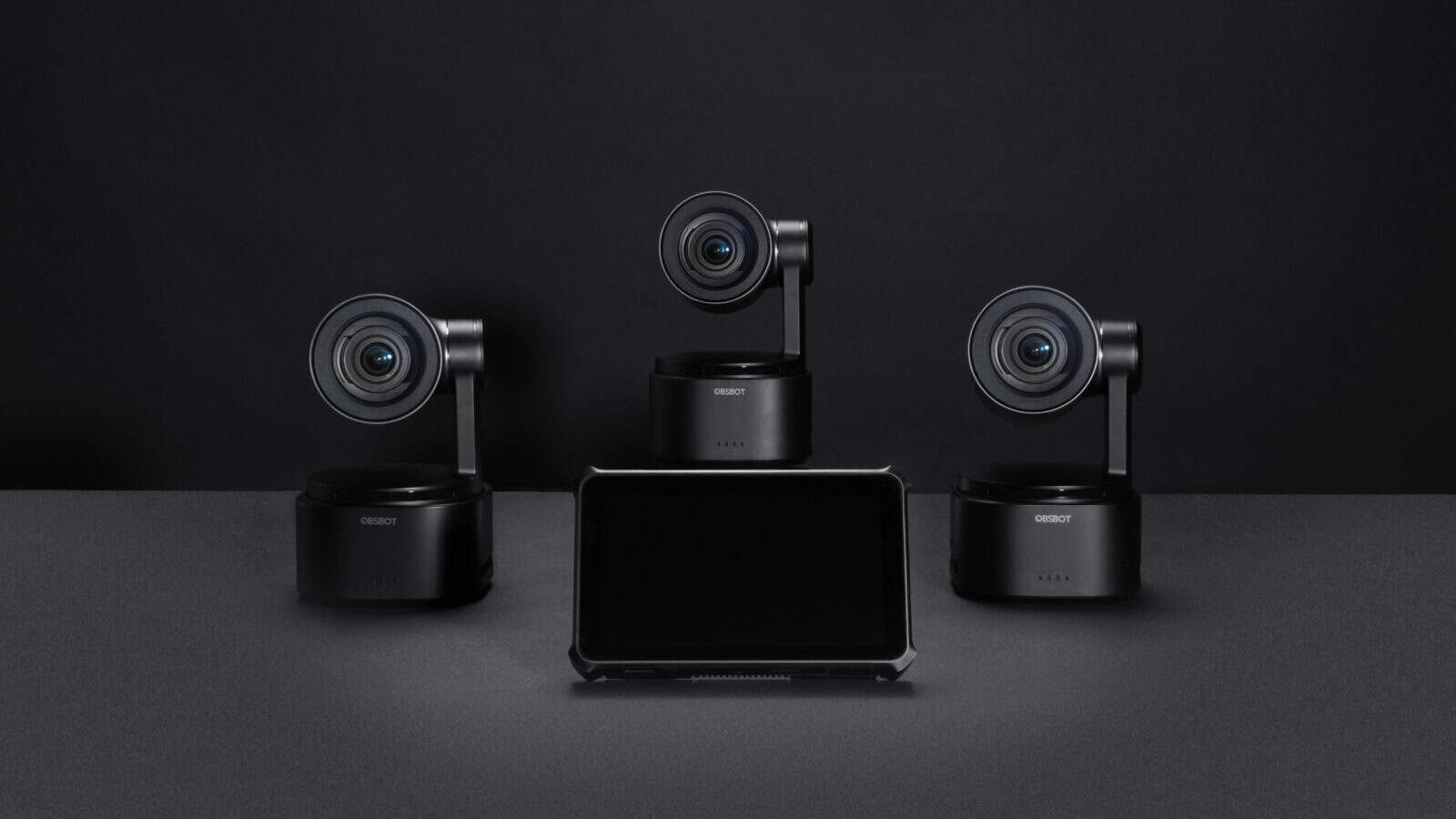 Three black cameras and a black monitor.