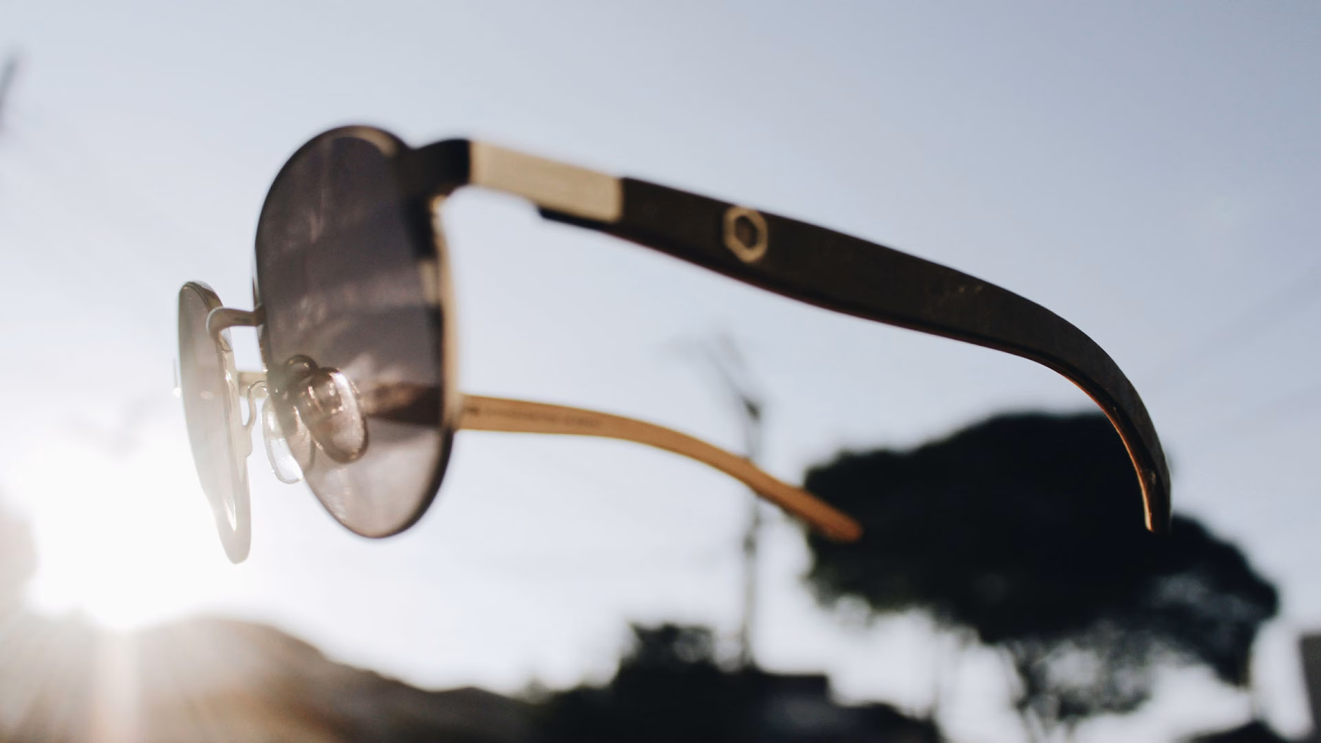 Sunglasses in sunlight with sky background.