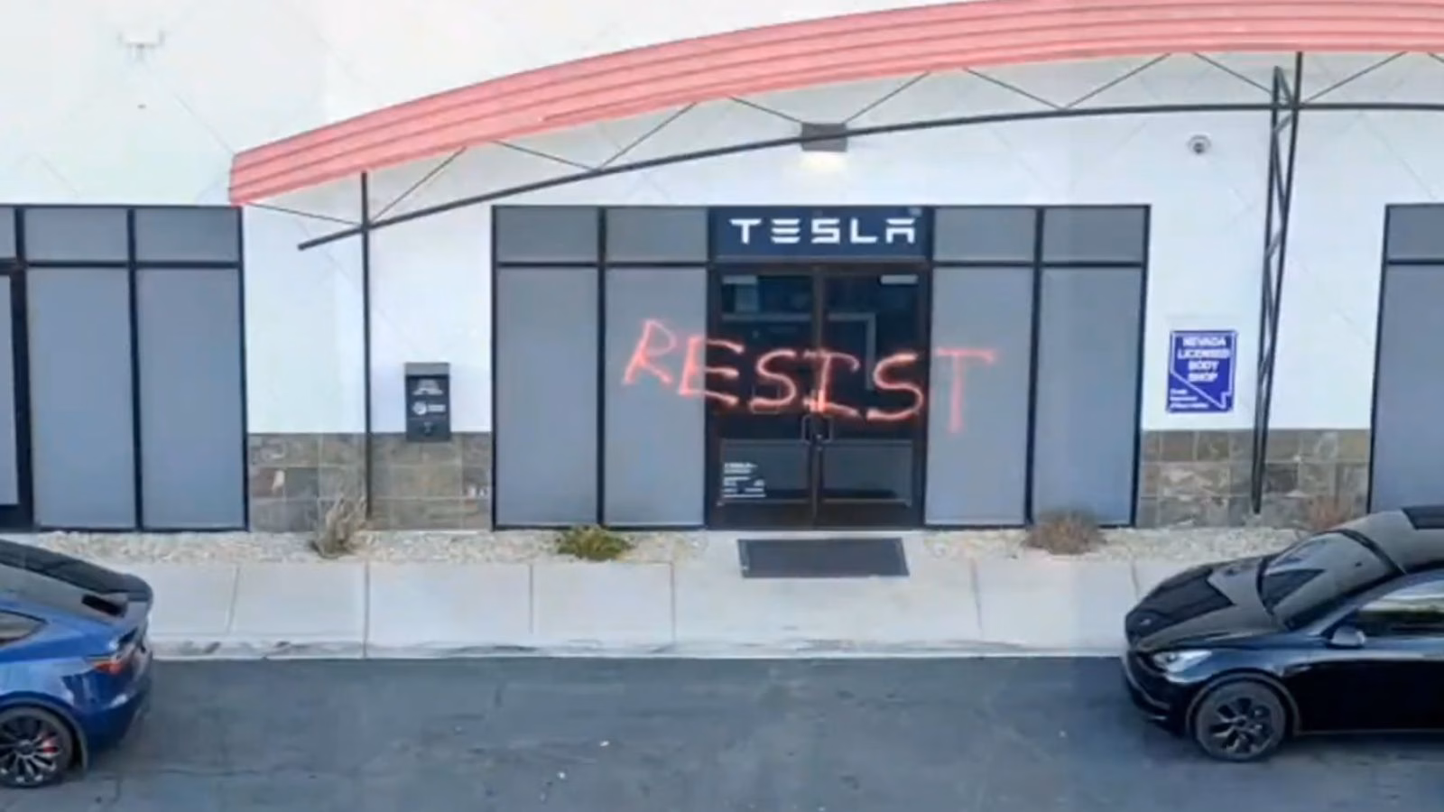 Tesla entrance with resist graffiti spray-painted.