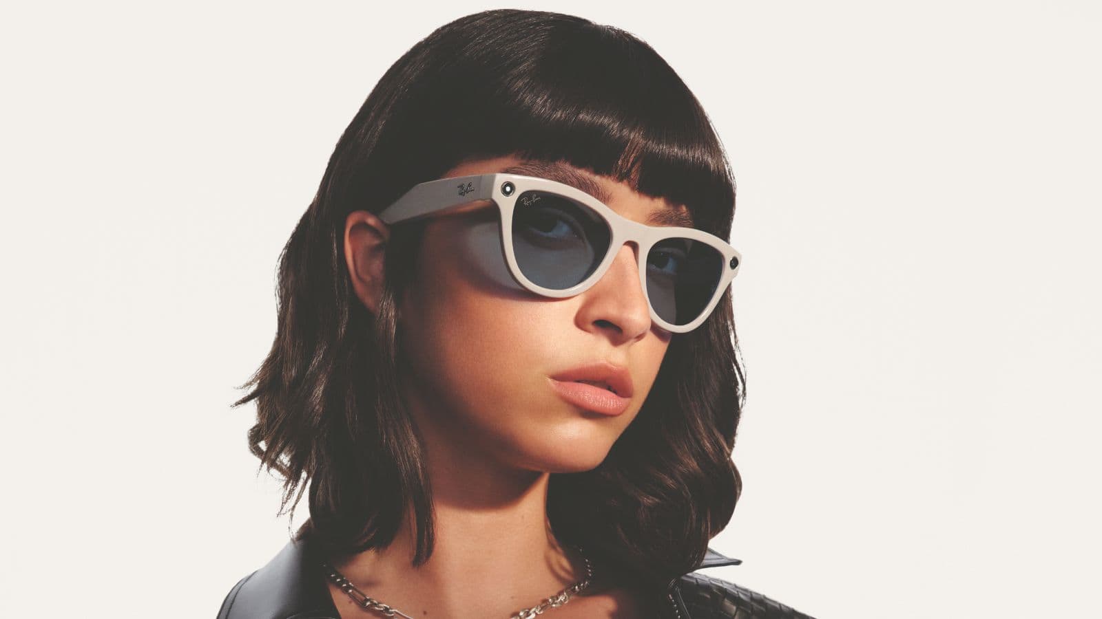 Person wearing stylish sunglasses indoors.