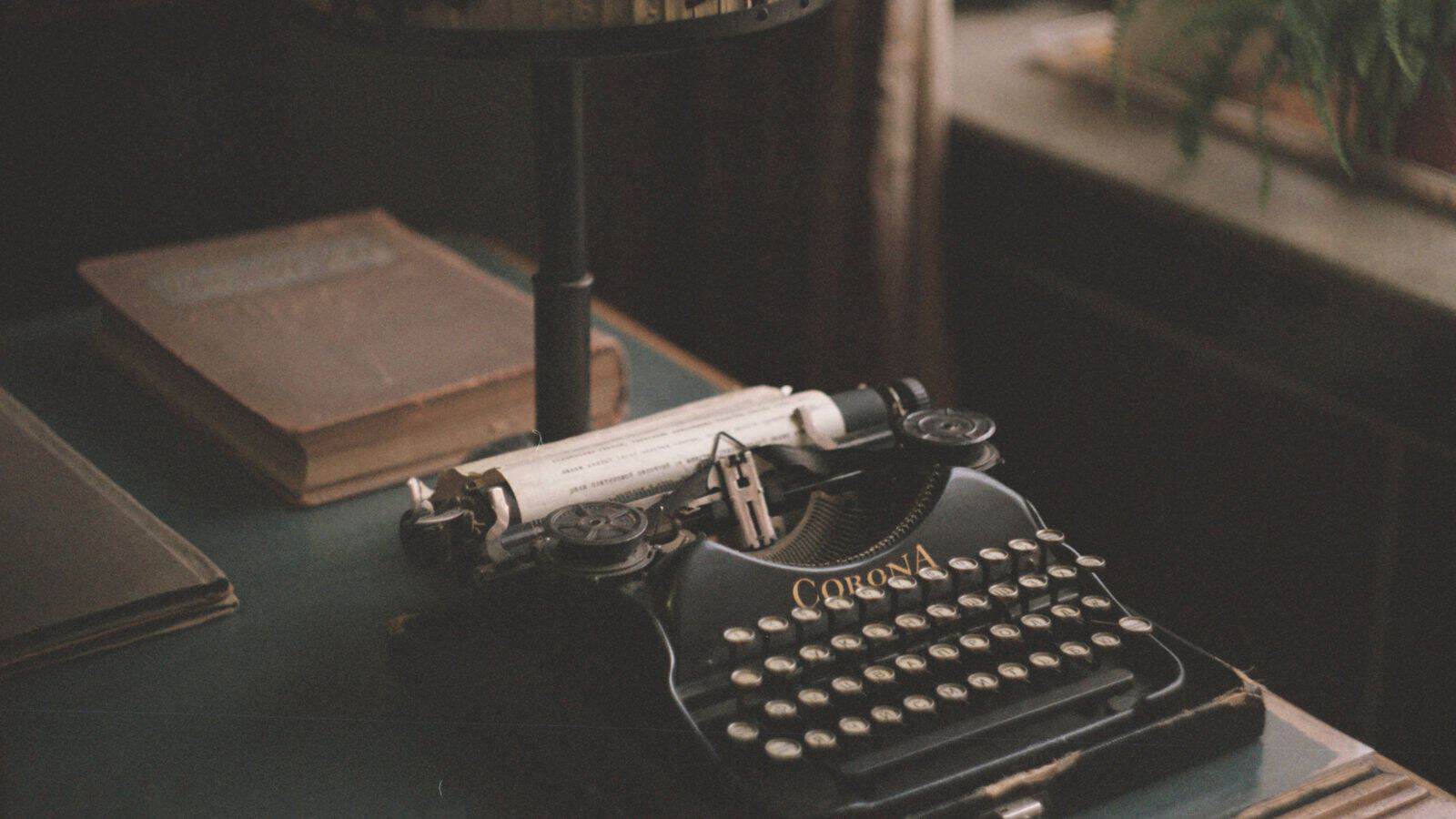 Vintage typewriter on a wooden desk.