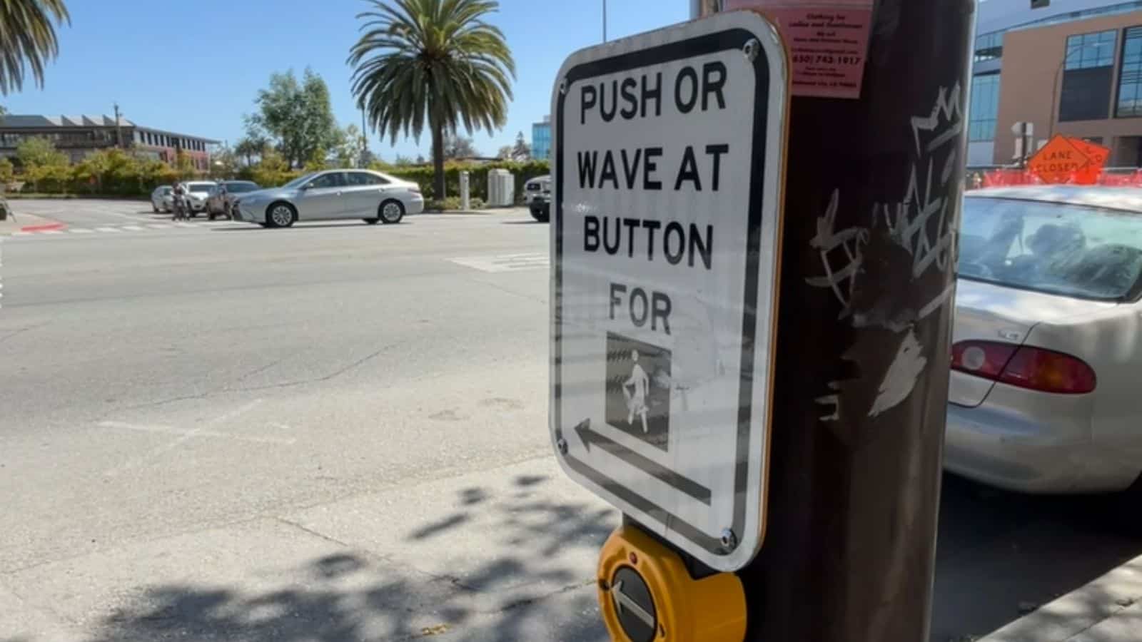 Crosswalk button with push or wave option.