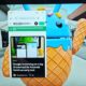 Android webpage open on laptop screen near statue.