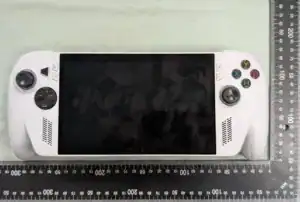 White handheld gaming console with rulers for scale.