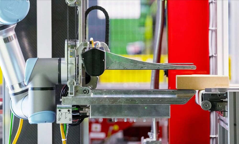 Robotic arm handling box in automated process