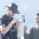 Filmmakers setting up camera equipment outdoors.