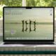 Laptop displaying nature wallpaper on a desk.