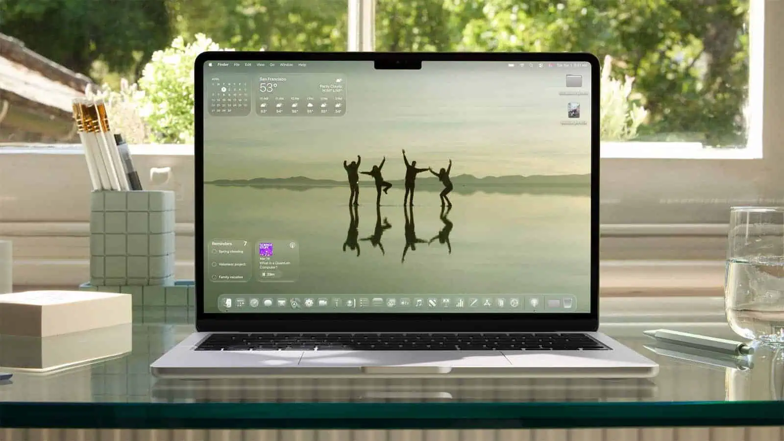Laptop displaying nature wallpaper on a desk.