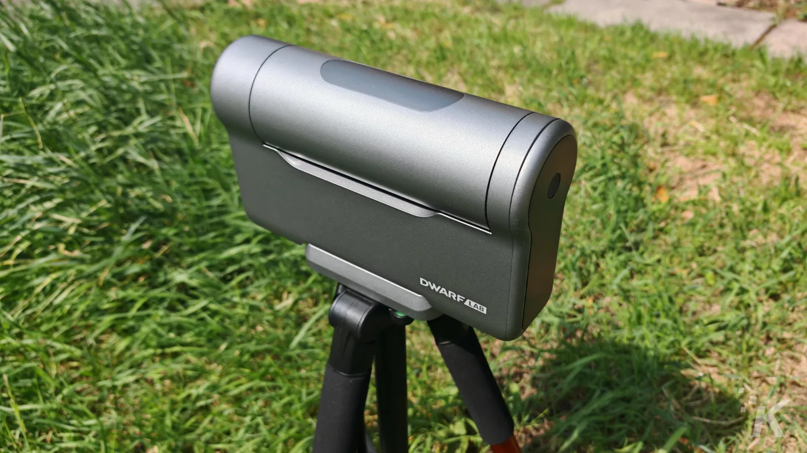 Outdoor telescope on tripod in grassy area.