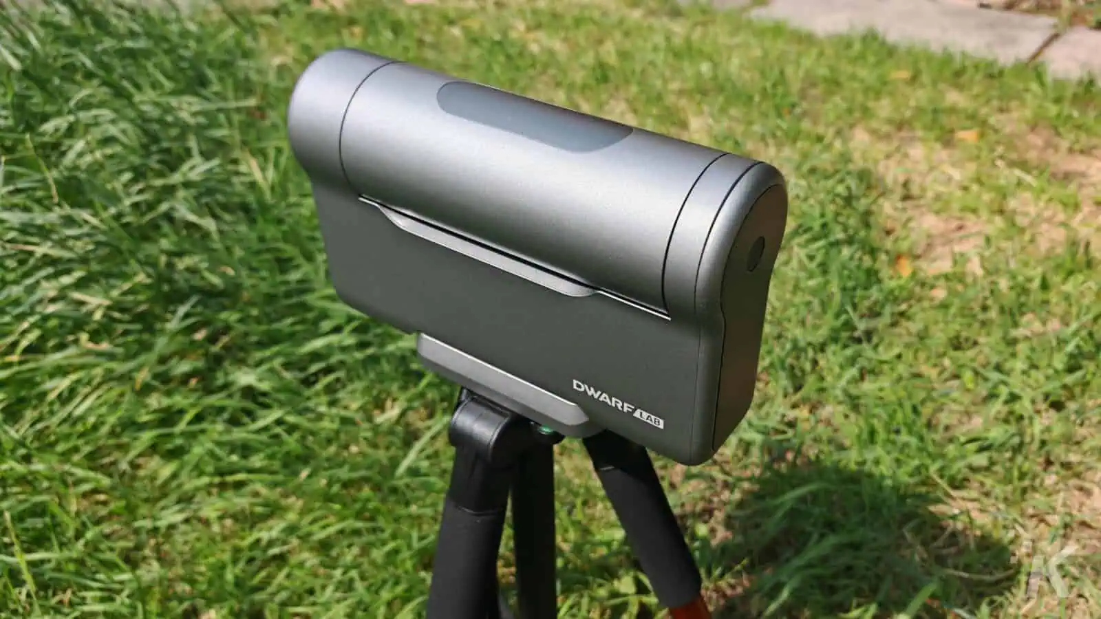 Outdoor telescope on tripod in grassy area.