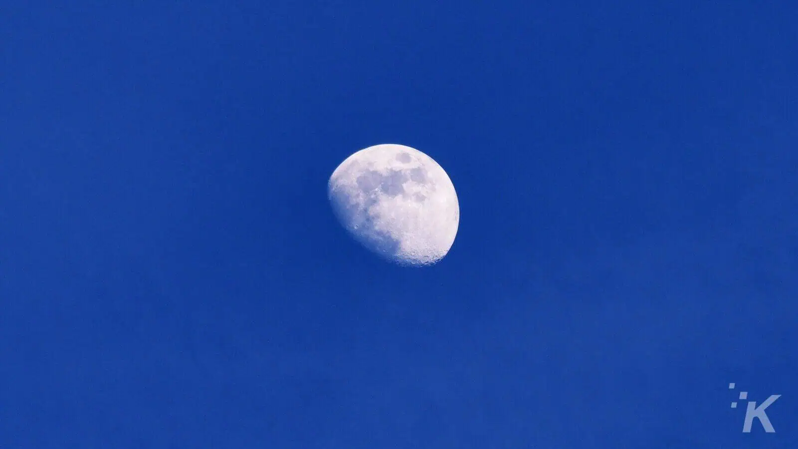 Moon in daytime blue sky