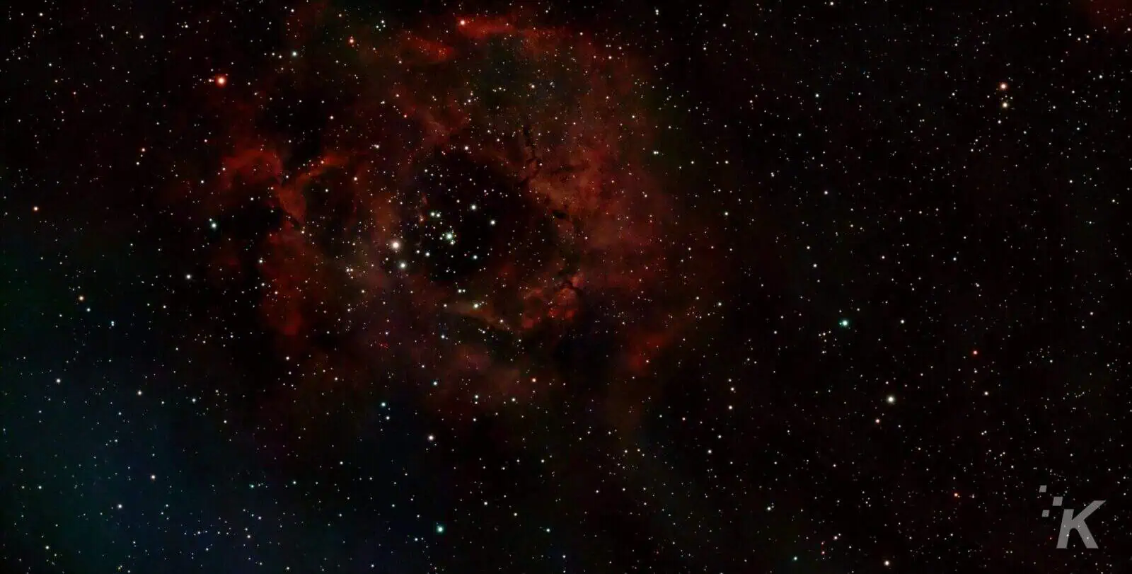 Rosette Nebula with bright stars and dark space.