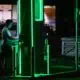 Person charging electric car at night station