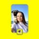 Woman and pug taking selfie at the beach
