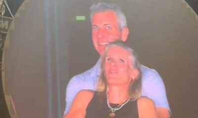 Man and woman smiling at event