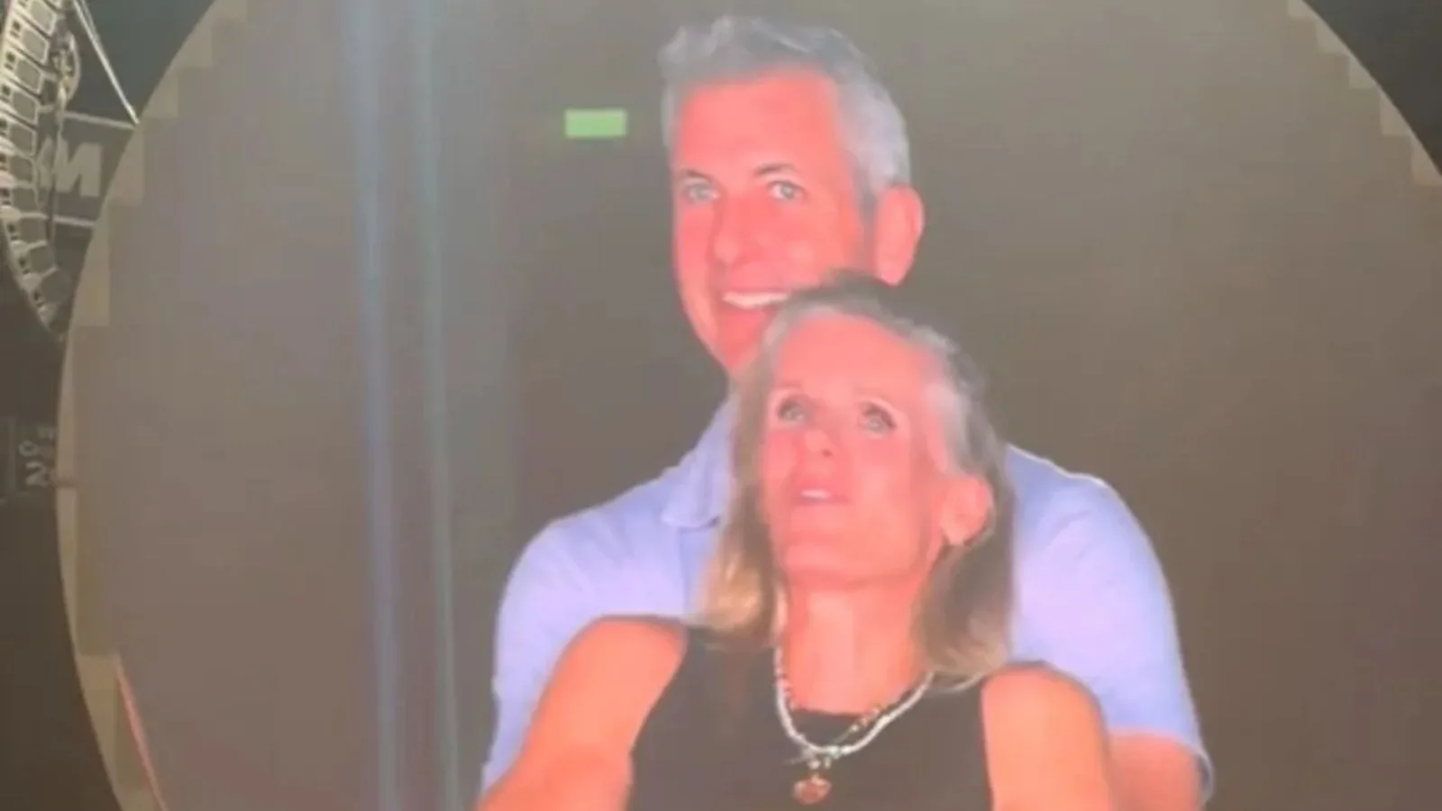 Man and woman smiling at event