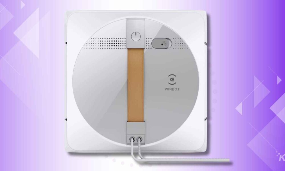 Automated window cleaning robot on purple background.