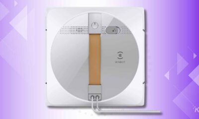 Automated window cleaning robot on purple background.