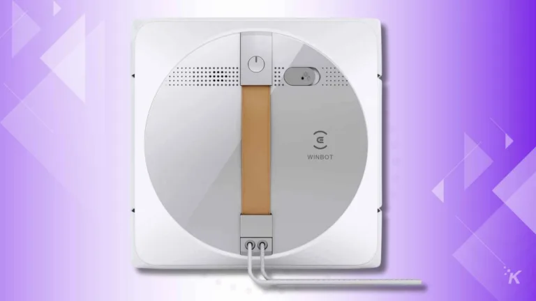 Automated window cleaning robot on purple background.