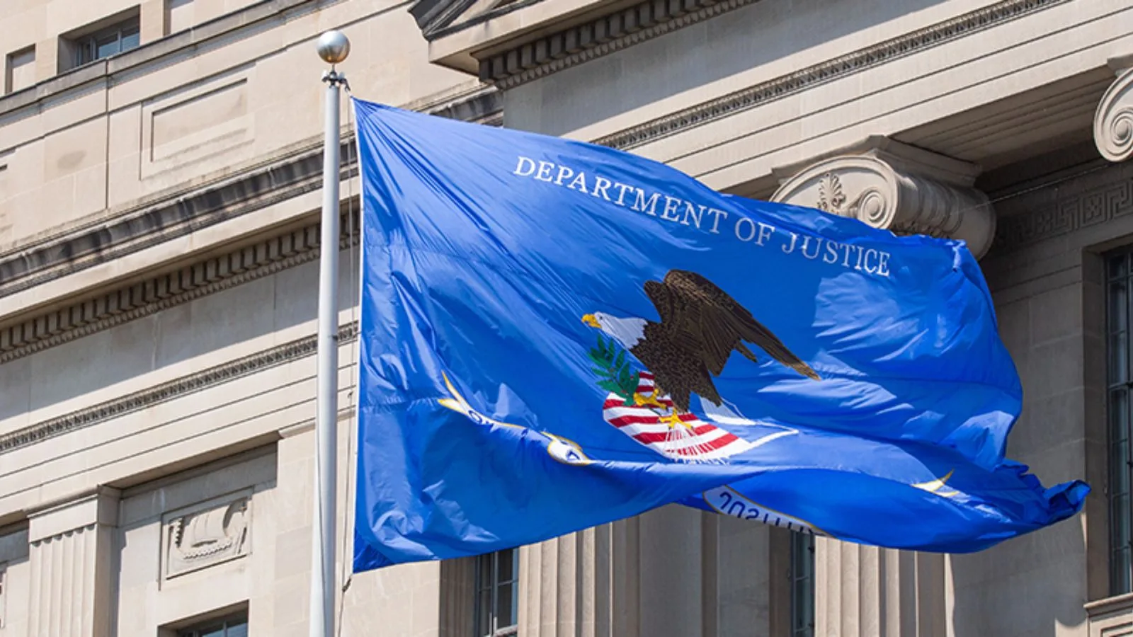 Department of Justice flag flying outdoors