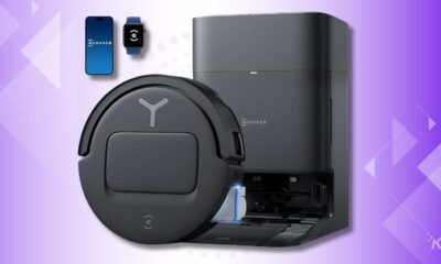 Smart robot vacuum and charging station on purple background