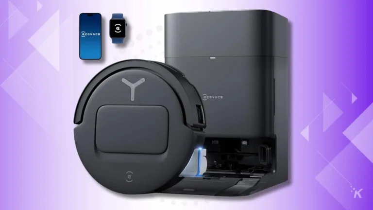 Smart robot vacuum and charging station on purple background