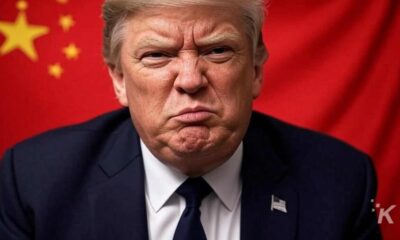 Trump in suit with China flag background