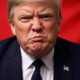 Trump in suit with China flag background