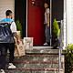 Delivery person brings packages to doorstep